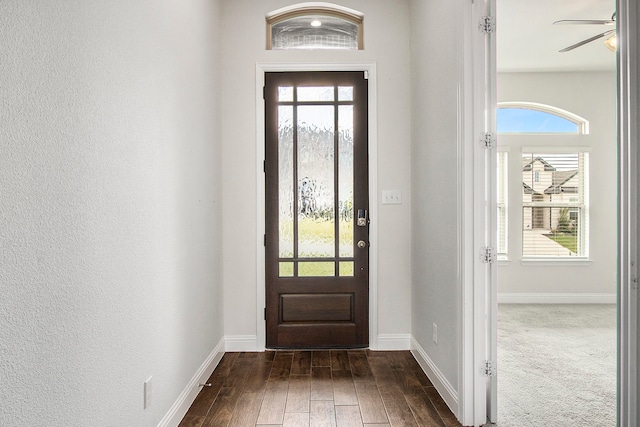 entryway featuring ceiling fan and dark wood-type flooring