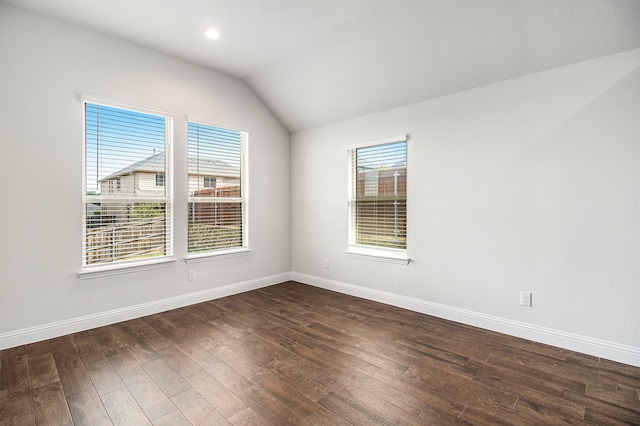 empty room featuring dark wood-type flooring and lofted ceiling