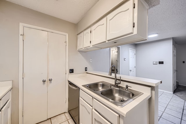 kitchen with dishwasher, kitchen peninsula, sink, white cabinetry, and a textured ceiling