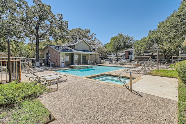 view of pool with a patio and a community hot tub