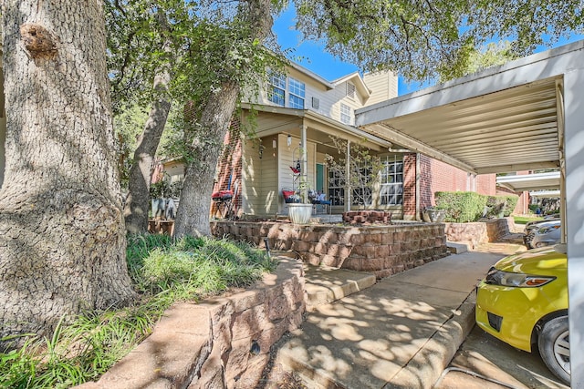 view of front of home featuring covered porch and a carport