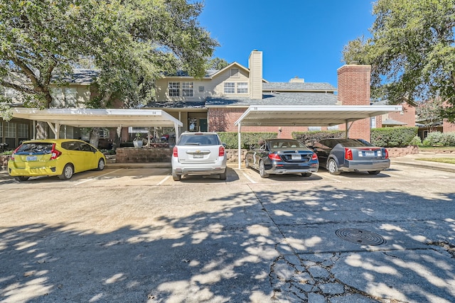 view of parking / parking lot featuring a carport