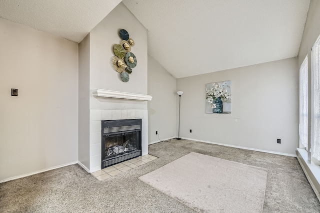 unfurnished living room with lofted ceiling, light carpet, a fireplace, and plenty of natural light