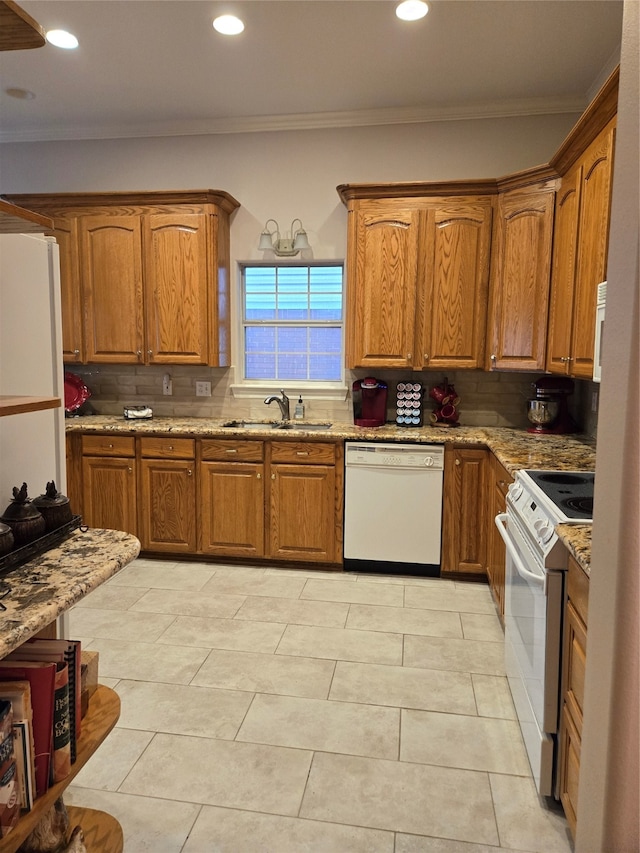 kitchen with white appliances, tasteful backsplash, crown molding, and sink