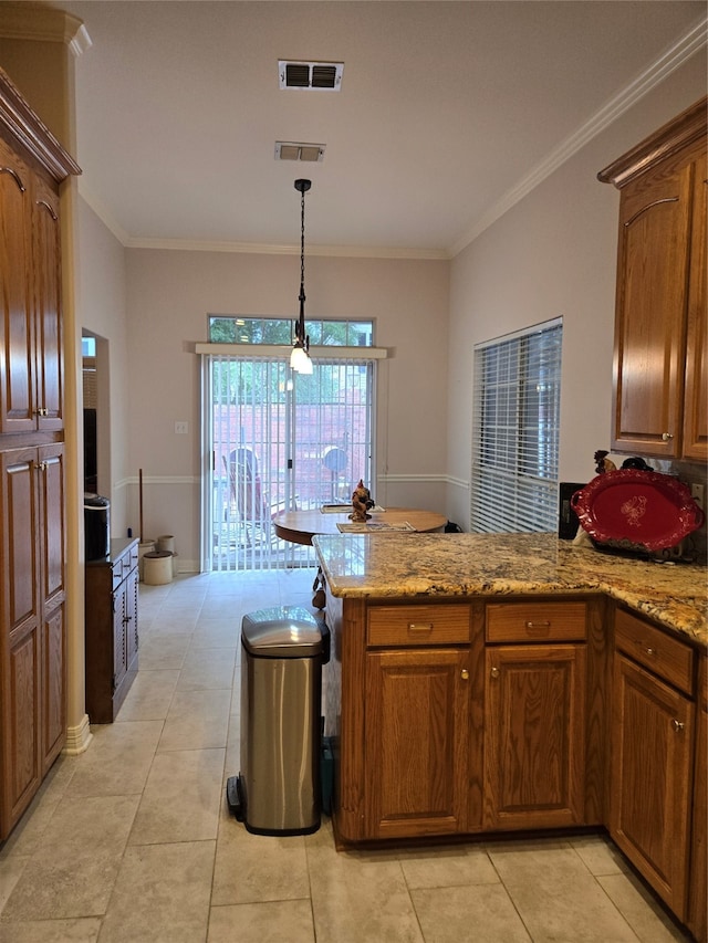 kitchen with ornamental molding, pendant lighting, light tile patterned flooring, and light stone countertops