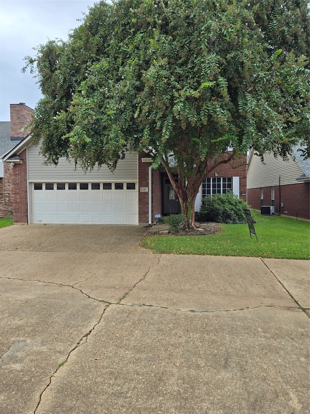 view of front of home with a garage and a front yard