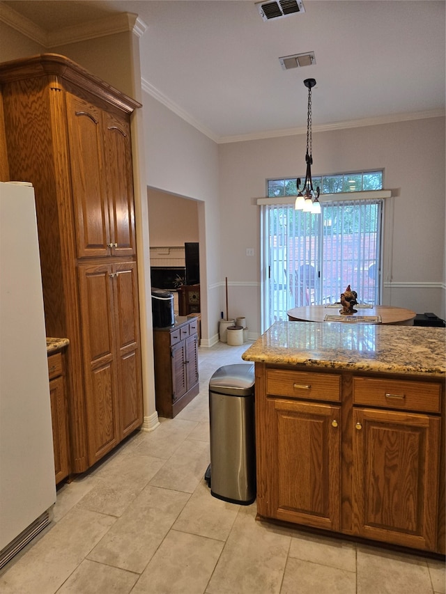 kitchen featuring light stone countertops, a chandelier, white fridge, pendant lighting, and ornamental molding