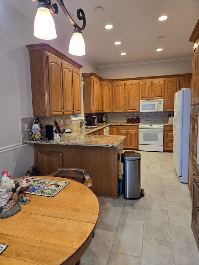 kitchen featuring crown molding, white appliances, kitchen peninsula, and tasteful backsplash