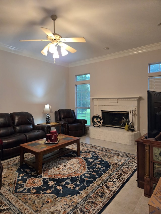 living room with ceiling fan, a fireplace, light tile patterned flooring, and ornamental molding