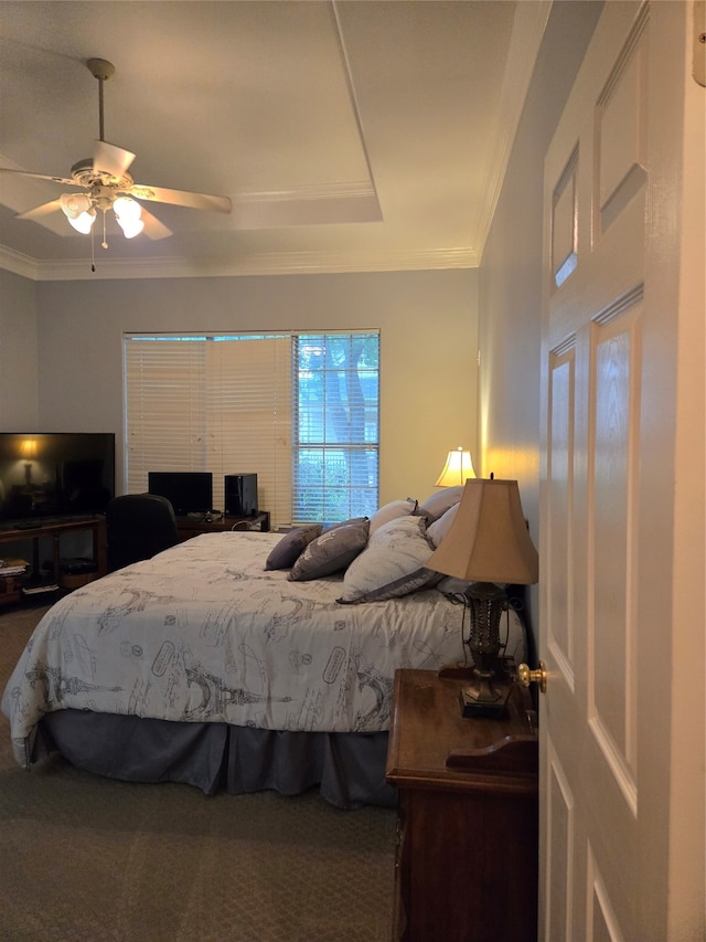 bedroom featuring ceiling fan, ornamental molding, and carpet floors