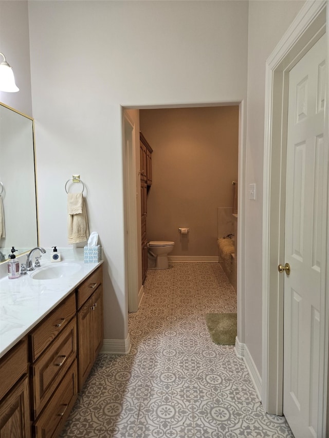 bathroom with vanity, toilet, and tile patterned floors