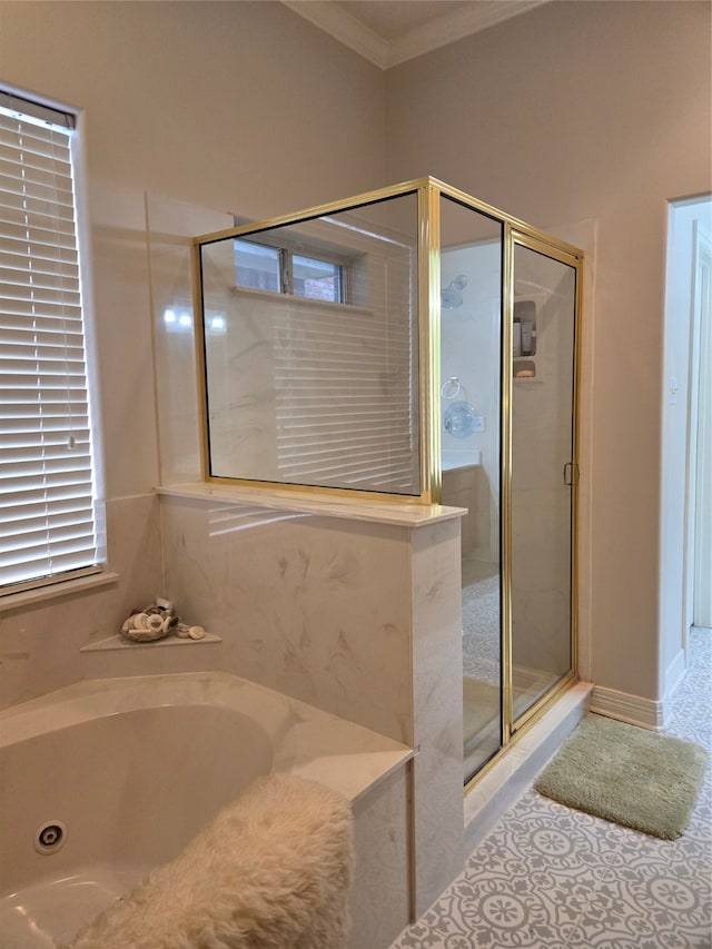 bathroom featuring ornamental molding and independent shower and bath