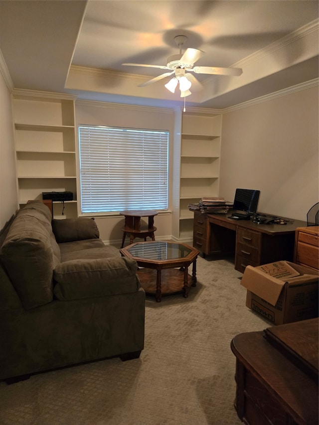 living room with a tray ceiling, ceiling fan, light colored carpet, and crown molding