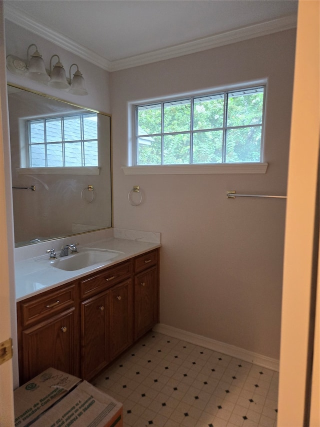 bathroom with ornamental molding and vanity