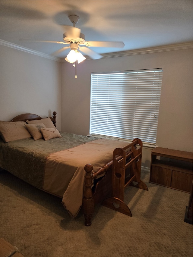 carpeted bedroom featuring ceiling fan and ornamental molding