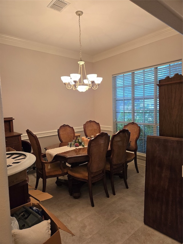 dining area featuring crown molding and an inviting chandelier