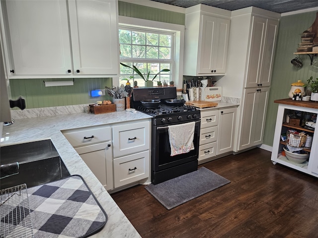 kitchen featuring gas range oven, white cabinets, sink, and dark hardwood / wood-style flooring