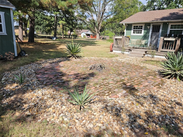 view of yard featuring a wooden deck