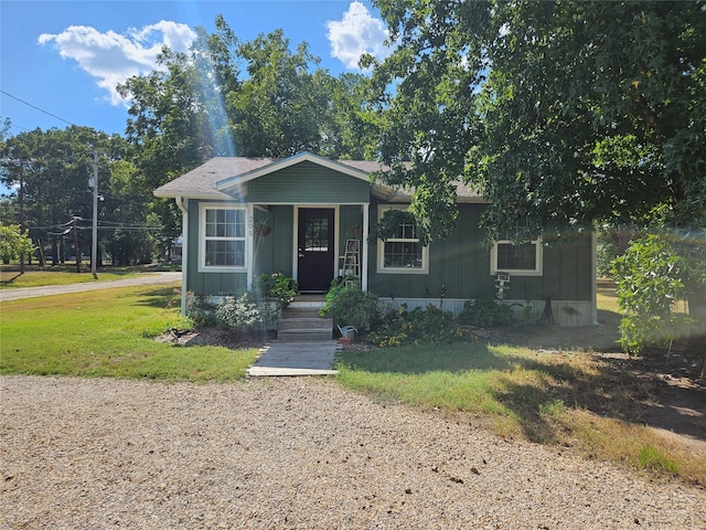 bungalow-style home featuring a front lawn