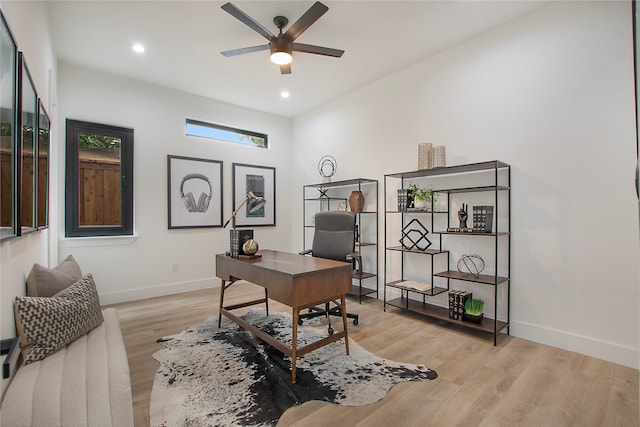 home office featuring light wood-type flooring and ceiling fan