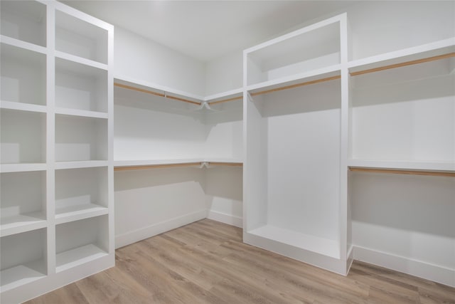 spacious closet featuring hardwood / wood-style flooring