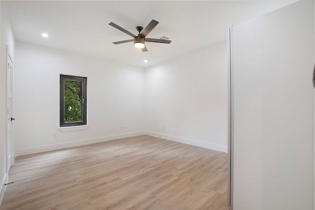 empty room featuring ceiling fan and light hardwood / wood-style floors