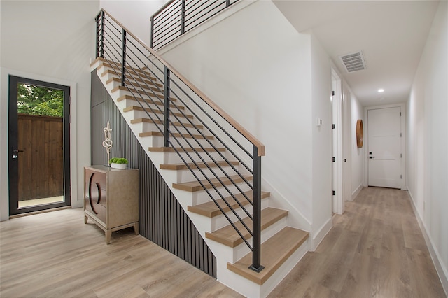 stairway featuring wood-type flooring