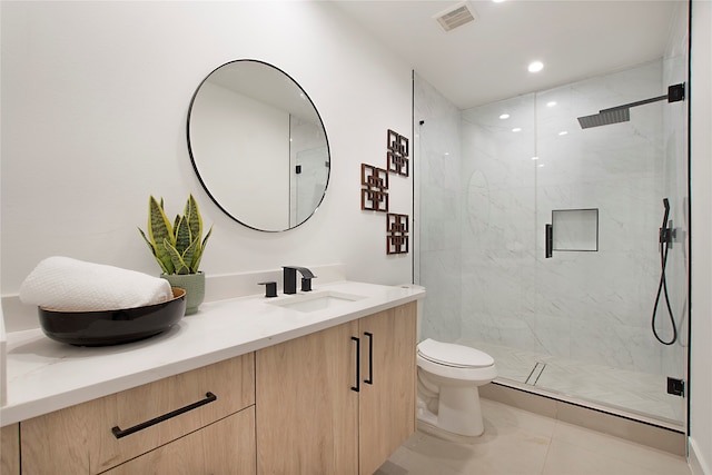 bathroom with tile patterned flooring, vanity, toilet, and an enclosed shower