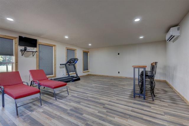 interior space featuring a wall mounted AC and wood-type flooring