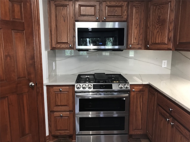 kitchen with stainless steel appliances and tasteful backsplash