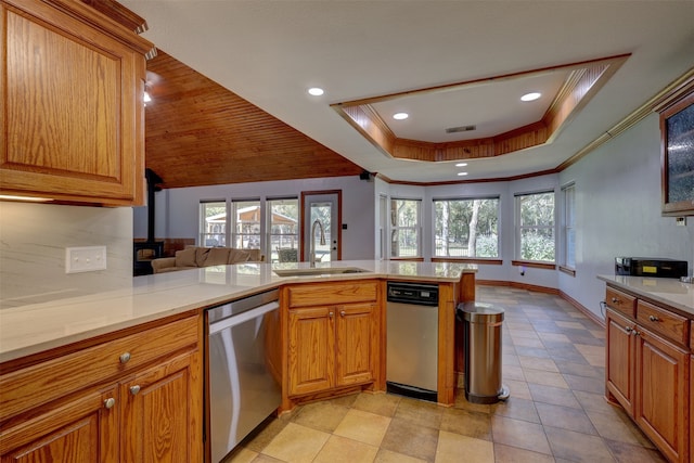 kitchen with plenty of natural light, sink, kitchen peninsula, and stainless steel dishwasher