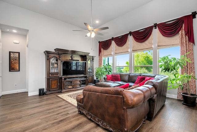 living room featuring hardwood / wood-style flooring, lofted ceiling, and ceiling fan