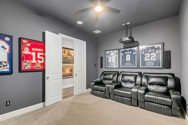 carpeted home theater room featuring ceiling fan