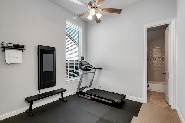 workout area with ceiling fan and carpet flooring