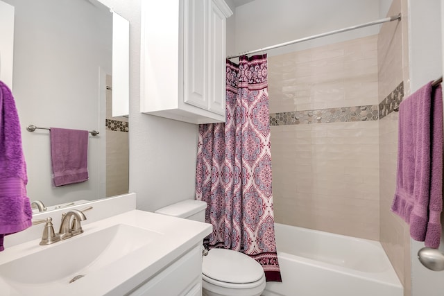 full bathroom with vanity, shower / tub combo, and toilet