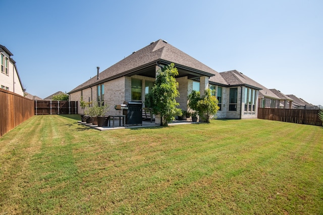 back of property with a patio area and a lawn