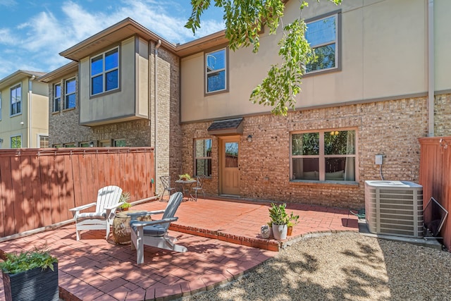 exterior space with cooling unit and a patio area