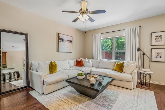 living room featuring ceiling fan and hardwood / wood-style flooring