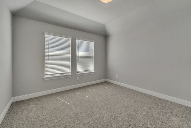 spare room with lofted ceiling and carpet floors