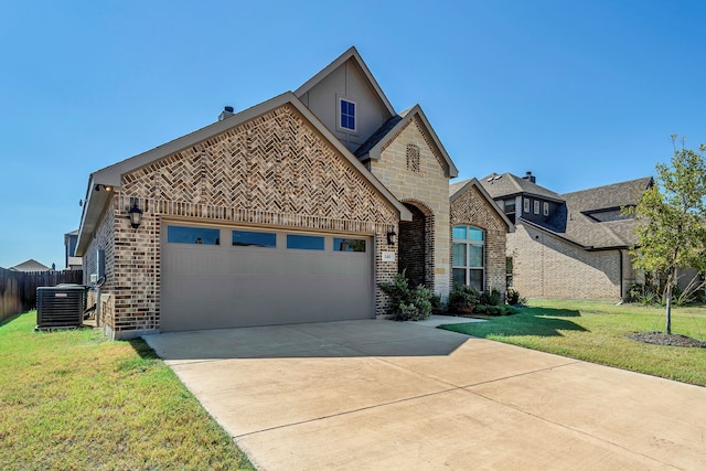 view of front of house featuring a garage, central AC unit, and a front yard