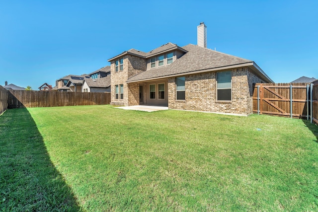 back of property featuring a patio area and a lawn