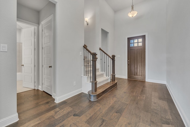 entrance foyer with a high ceiling and dark hardwood / wood-style flooring