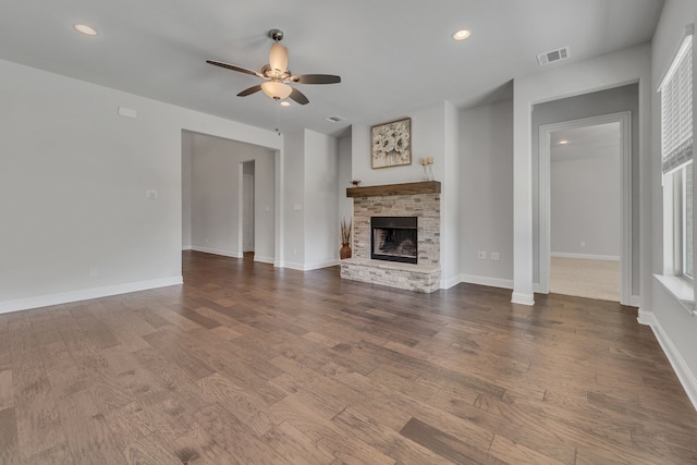 unfurnished living room with a fireplace, wood-type flooring, and ceiling fan