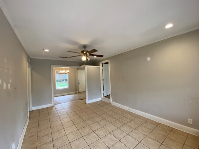 tiled empty room featuring ornamental molding and ceiling fan with notable chandelier