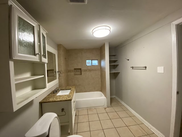 full bathroom featuring tile patterned floors, toilet, tiled shower / bath combo, and vanity