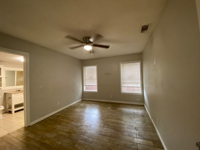 empty room featuring hardwood / wood-style floors and ceiling fan