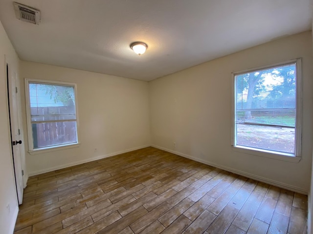 spare room with light wood-type flooring