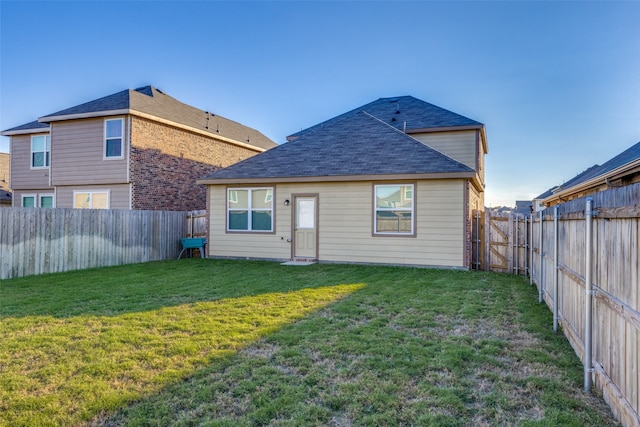 rear view of property with a lawn