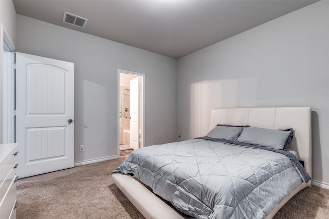 carpeted bedroom featuring ensuite bathroom