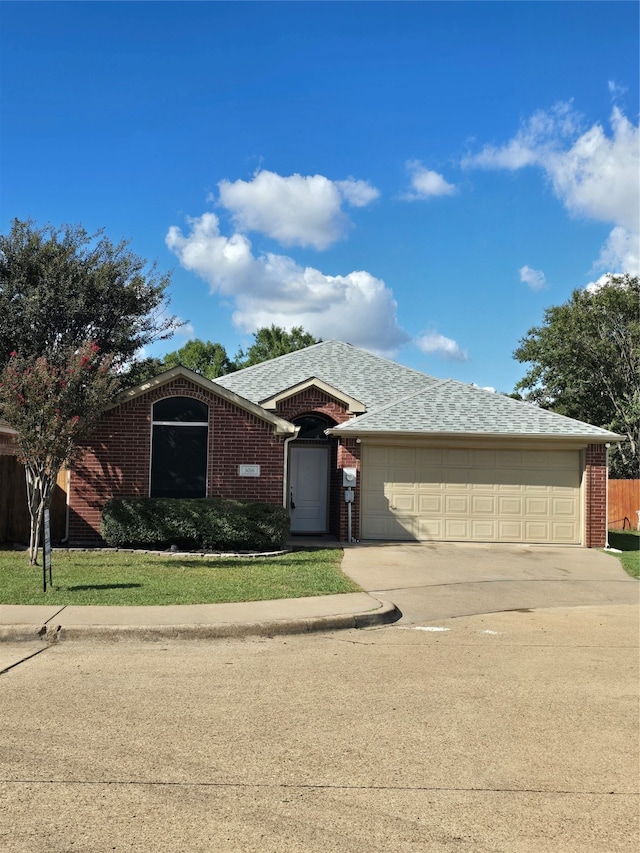 view of front of home with a garage and a front lawn